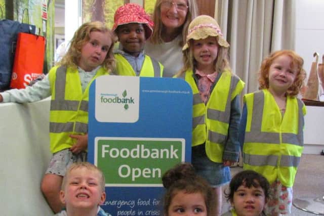 Jan Martin with the children from The Hampton Day Nursery at the local Food Bank