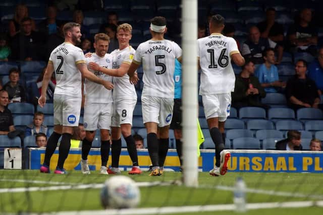 Matt Godden of Peterborough United (second from left) celebrates his opening goal with team-mates. Picture: Joe Dent
