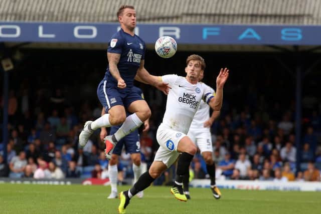 Alex Woodyard of Peterborough United in action with Simon Cox of Southend United. Picture: Joe Dent