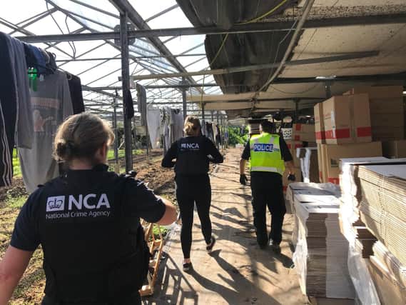 Police and National Crime Agency officers executing the warrant in Cambridgeshire