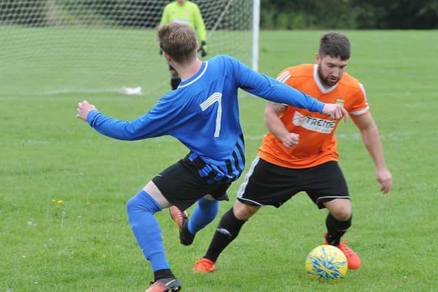 Action from the Peterborough Premier Division game between Thorney (orange) and Moulton Harrox. Photo: David Lowndes.
