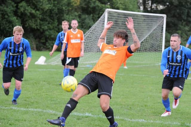 Action from Thorney's 1-0 home defeat at the hands of Moulton Harrox (blue). Photo: David Lowndes.