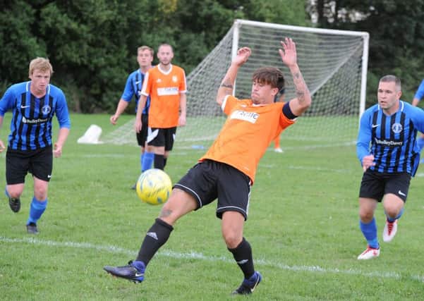 Action from Thorney's 1-0 home defeat at the hands of Moulton Harrox (blue). Photo: David Lowndes.