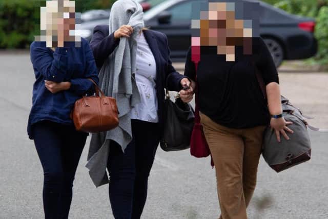 Drinkwater covers her face as she arrives at court
