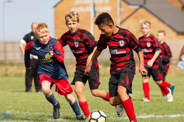 Action from the game between Park Farm Pumas Blue Under 12s and Wittering Harriers Under 12s.
