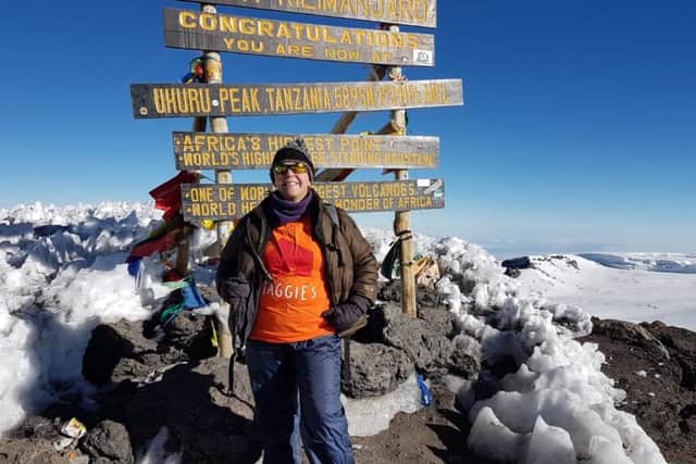 Tina at the Summit of Kilimanjaro in her Maggie's T Shirt