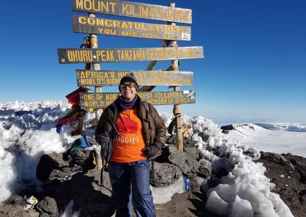 Tina at the Summit of Kilimanjaro in her Maggie's T Shirt