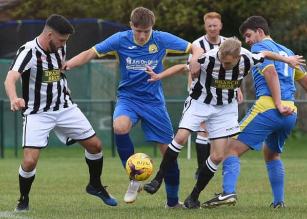 Action from Peternorough Northern Star's FA Vase win over March. Star are in the stripes. Photo: Chatelle McDonald. @cmcdphotos.