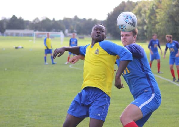 Posh deaf team player Henry Rosier (blue) challenges for possession in the 7-3 win over St Albans.