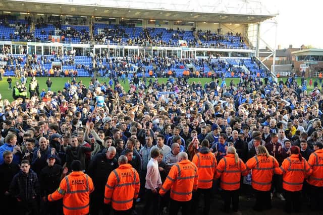 Posh fans on the pitch after a win over Sheffield Wednesday in April, 2013.