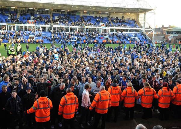 Posh fans on the pitch after a win over Sheffield Wednesday in April, 2013.
