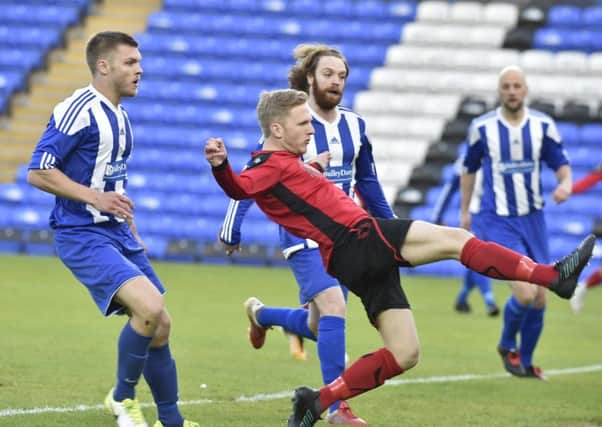 Action from last season's PFA Senior Cup Final between Netherton (red) and Moulton Harrox.