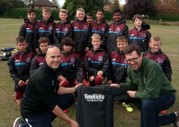 Thorpe Wood Rangers Under 12s are pictured receiving rain jackets from Steve Thorpe of sponsors FreeKicks Foundation before a 4-2 win over Blackstone in a Peterborough Junior Alliance Under 12 Divison Four game.