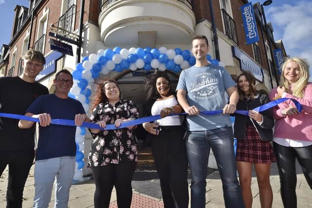 Store manager Alexandra Gibb, centre, cuts the ribbon to officially open the new BadRhino store in Peterborough watched by staff.