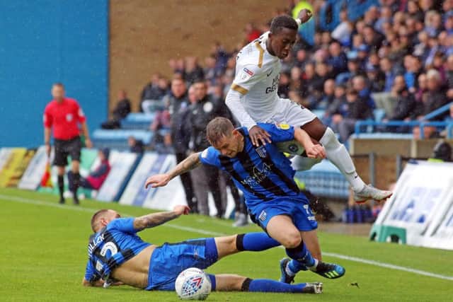 Posh winger Siriki Dembele is brought down by two Gillingham players. Photo: Joe Dent/theposh.com.