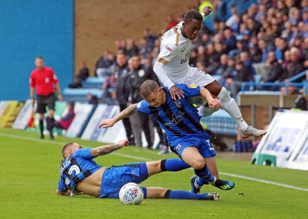 Posh winger Siriki Dembele is brought down by two Gillingham players. Photo: Joe Dent/theposh.com.