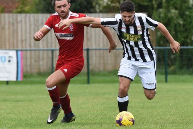 Zak Dunn (stripes) of Peterborough Northern Star in action against Oadby Town. Photo: Chantelle McDonald. @cmcdphotos.