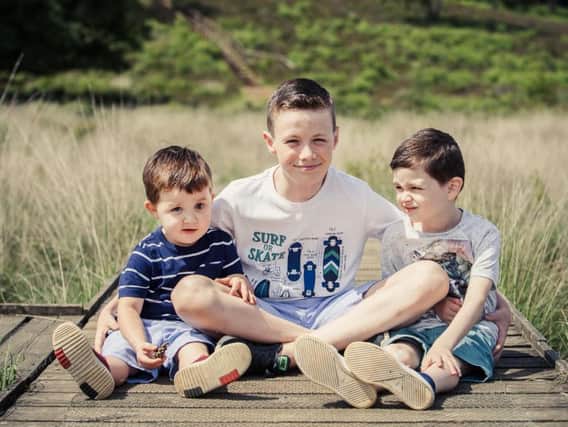 Logan Brown, left, with older brothers Liam, and Jenson.