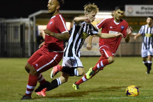 Lukas Gereltauskas (stripes) of Peterborough Northern Star in action against Boston Town. Photo: Chantelle McDonald. @cmcdphotos.