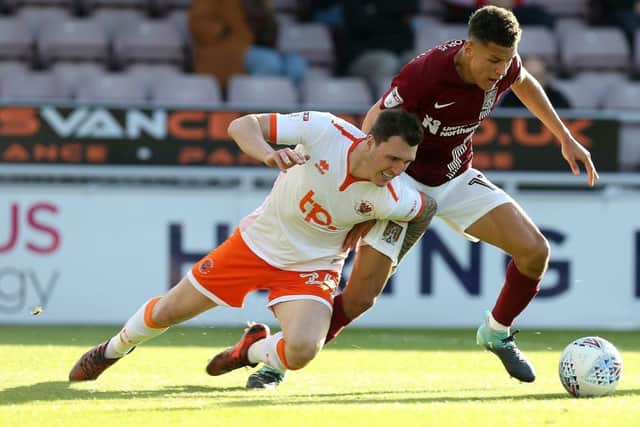Callum Cooke (left) in action for Blackpool last season.