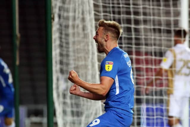 Posh striker Matt Godden celebrates a late goal in a Checkatrade Trophy game at MK Dons.