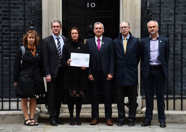 (left to right) Headteachers Sharon Waldron from Stonham Aspal primary school in Suffolk, Andrew Lund from Appleby Grammar in Cumbria, Emma Wilkes from Oakfield Academy in Somerset, Anthony Markham from Herne Junior School in Hampshire, Jonathan Digby from Sir Harry Smith Community College in Peterborough and Adrian Carver from Downs View School in Brighton, stand outside Number 10 Downing Street, London, as they deliver a letter to the Chancellor to demand extra cash. 
Picture: Kirsty O'Connor/PA Wire