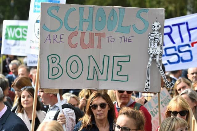 Headteachers from across England and Wales hold signs in Parliament Square, London, as they prepare to march on Downing Street to demand extra cash for schools.  Picture: Kirsty O'Connor/PA Wire