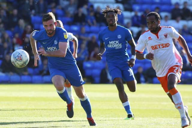Posh full-back Jason Naismith chases a through ball with Nathan Delfouneso of Blackpool. Photo: Joe Dent/theposh.com.