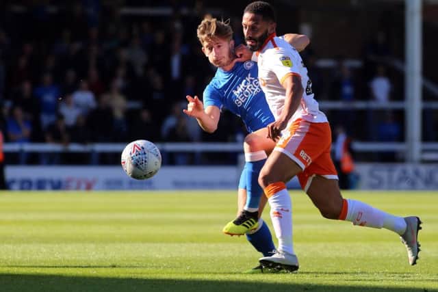 Alex Woodyard battles with Blackpool's Liam Feeney. Photo: Joe Dent/theposh.com.