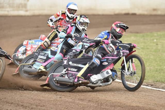 Heat one action from Panthers v Lakeside with Thomas Jorgensen (red helmet) and Simon Lambert (blue) riding for the city side. Photo: David Lowndes.