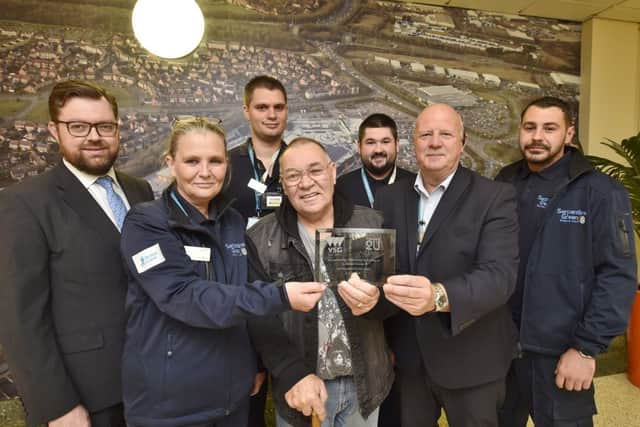 Heart attack survivor Frank Dawson hands an award to staff at Serpentine Green who saved his life. David Leonard, Sam Elsworth, Dean Kent, Craig Taylor, Ray Woods and Jason Ellis EMN-180310-083156009