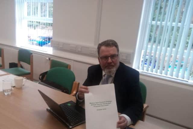Cabinet member for resources Cllr David Seaton with a copy of the budget