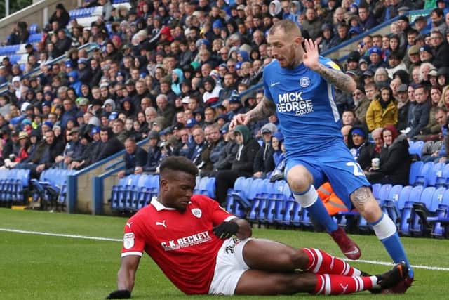 Marcus Maddison of Peterborough United is fouled by Dimitri Cavare of Barnsley which resulted in the Peterborough United player going off injured. Photo: Joe Dent/theposh.com