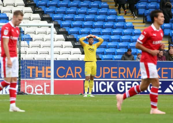 Aaron Chapman of Peterborough United stands dejected after Barnsley score their fourth goal of the game. Photo: Joe Dent/theposh.com.