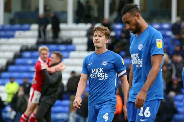 Alex Woodyard and Rhys Bennett of Peterborough United leave the pitch after a 4-0 home hammering at the hands of Barnsley. Photo: Joe Dent/theposh.com.