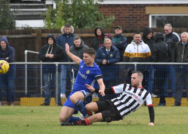 Peterborough Sports skipper Mark Jones is tackled strongly by a Chorley player. Photo: James Richardson.