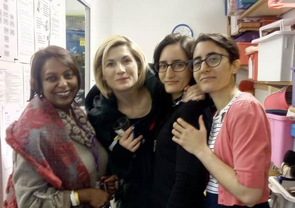 Charity shop manager Tams Mukhopadhyay with Jodie Whittaker and Marta and Alicia Sachs