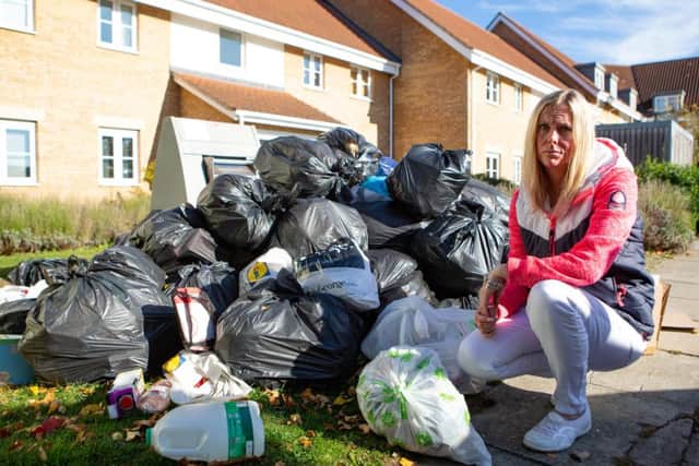 Kelly McKenzie with the large pile of rubbish in Lime Kiln Close