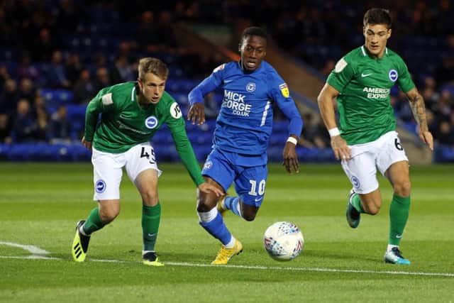 Posh winger Siriki Dembele darts between two Brighton defenders. Photo: Joe Dent/theposh.com.