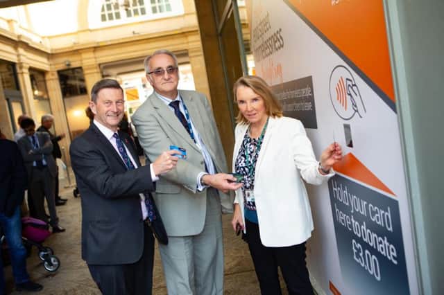 Safer off the Streets: Cllr Steve Allen, John Holdich and Irene Walsh demonstrate how easy it is to donate Â£3 by swiping your card outside Argo Lounge.

Picture by Terry Harris / Peterborough Telegraph. THA