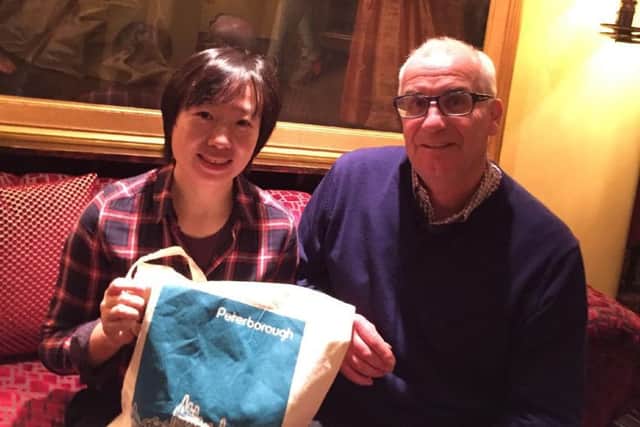 Chinese coach Chen Min receives a memento of her visit to Peterborough from Archway club development officer Diccon Gray.