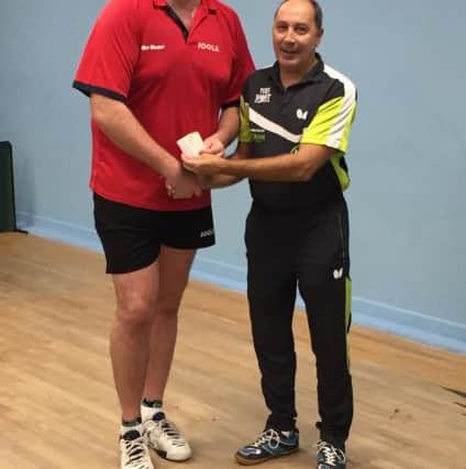 Tournament winner Chris Doran (left) receives his prize.