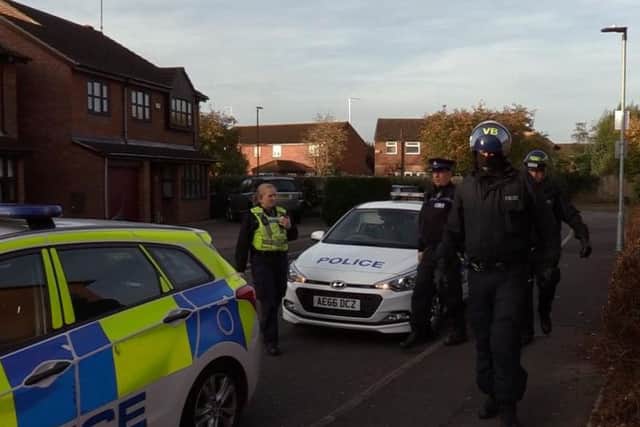 Police in Peterborough during one of the raids in the city yesterday