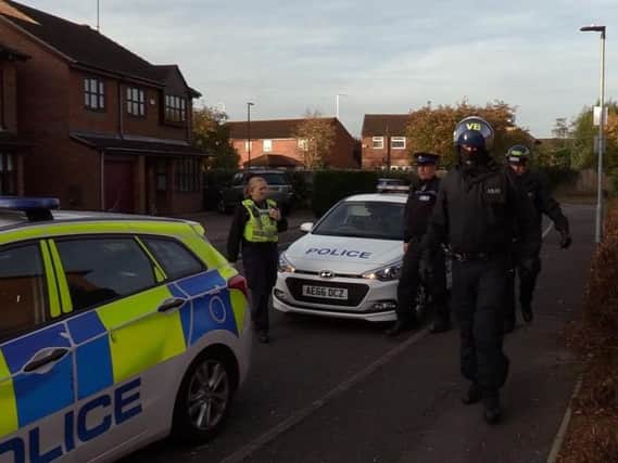 Police in Peterborough during one of the raids in the city yesterday