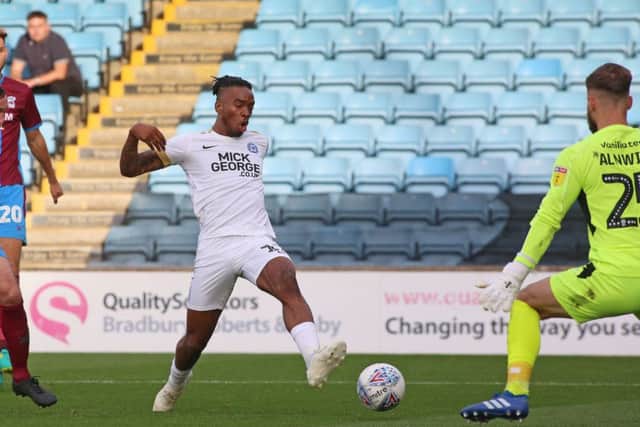 Posh substitute Ivan Toney is denied by Scunthorpe 'keeper Jak Alnwick.