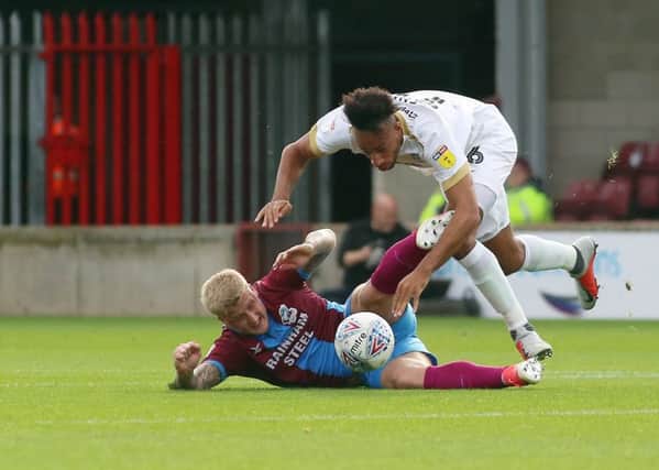 Rhys Bennett of Peterborough United in action with Stephen Humphrys of Scunthorpe United. Photo: Joe Dent/theposh.com.