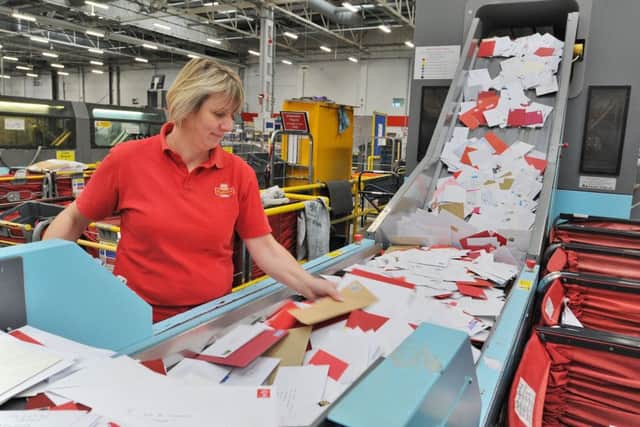 Busiest day at the letter sorting office at Werrington for the Christmas post. Lynn Stevens loading sorting machines EMN-171213-131916009