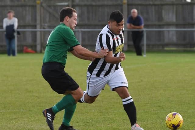 Christian Le (stripes) of Peterborough Northern Star in action against Sleaford Town. Photo: Chantelle McDonald. @cmcdphotos.