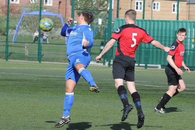 Action from a 6-1 win for Netherton United Reserves (red) over Warboys in Peterborough Division Two. Photo: David Lowndes.
