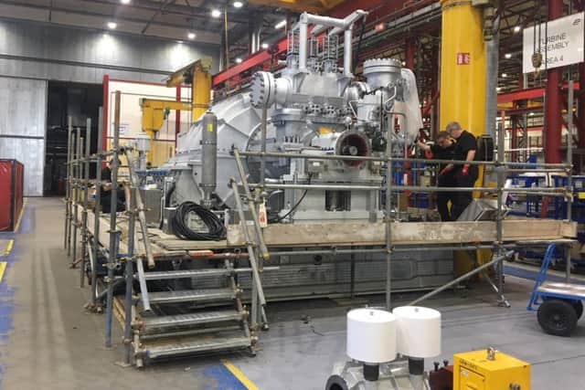 Engineeers work on the 45 tonne steam turbine.